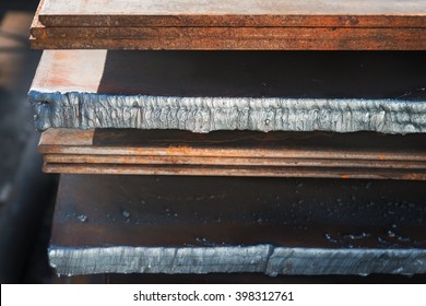 Large metal plates with fused edges of the plant, close-up.