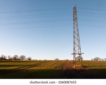 Large Metal Tower Field Farm Blue Sky Electric Pylon Communication Power Supply Background; Essex; England; Uk