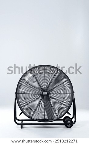 Large, metallic fan and electric appliance with blades, steel and industry on gray studio background. Empty, breeze and air conditioning with mockup space, promotion for product and stationary