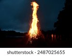 Large Midsummer bonfire at night in Latvia. Burning bonfire with dark background