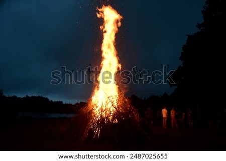 Large Midsummer bonfire at night in Latvia. Burning bonfire with dark background