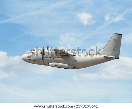 Large military transport cargo plane flying over Bucharest. Plane prepairing for landing.
