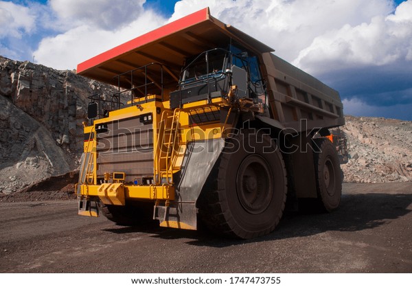 A\
large mining dump truck transports ore in a\
quarry