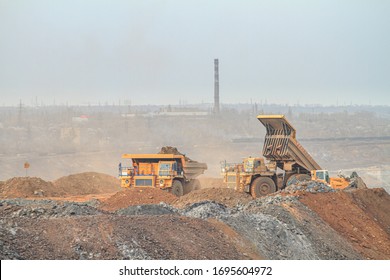 A Large Mining Truck Dumps Waste Rock To A Dump