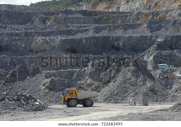 Large mining truck in\
limestone quarry.
