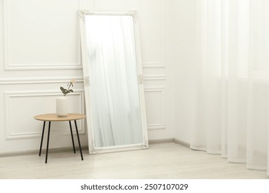 Large mirror near white wall in room. Interior design