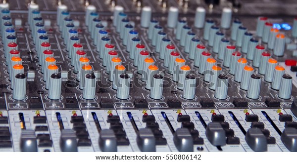 Large\
mixing console shot close-up during\
operation