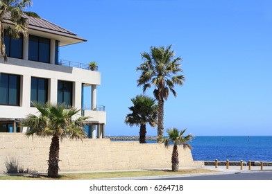 Large Modern House By The Beach, Surrounded By Palm Trees.