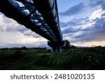 A large modern industrial aqueduct that spans the length of a river in Japan. 