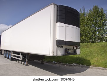 Large Modern Refrigerated Truck Trailer Freight, Place Advert On White. White Refrigerator Truck Trailer Container For Transport Of Cold Chilled Food.