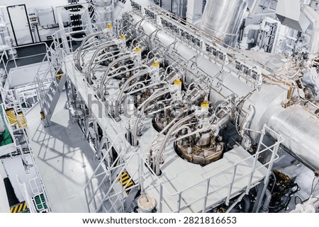 Large Modern Ship Engine Room with Main Diesel Propulsion System and Piping
