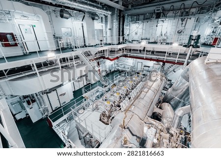 Large Modern Ship Engine Room with Main Diesel Propulsion System and Piping