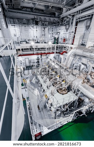 Large Modern Ship Engine Room with Main Diesel Propulsion System and Piping
