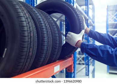 Large Modern Warehouse With Forklifts And Stack Of Car Tires