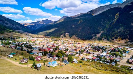 Large Mountain Range Surrounding Small Western Town In Valley