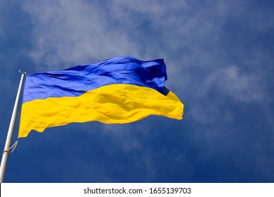 Large national flag of Ukraine  flies in the blue sky. Big yellow blue Ukrainian state banner in the Dnepr city, Dnepropetrovsk. Independence, flag, Constitution Day, National Holiday, text space - Shutterstock ID 1655139703