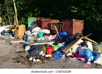 A Large Number Of Accumulated Plastic Bags And Plastic Packaging Of Household Waste In Garbage Containers. The Problem Of Garbage Removal From The Village, The Concept Of Environmental Pollution