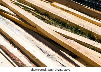 A Large Number Of Boards Lie On The Construction Site, Parts Of Raw Building Materials Are Used In Industry And Construction