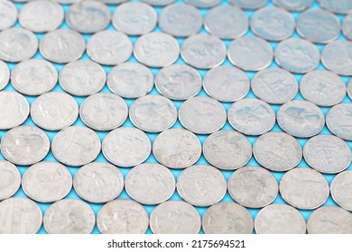 A Large Number Of Coins Spread Out In The Background