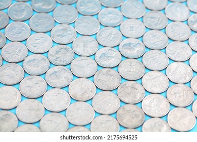 A Large Number Of Coins Spread Out In The Background