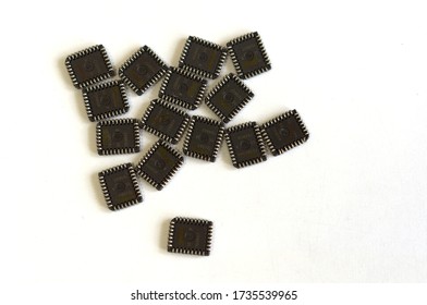 A large number of microchips, microcircuits on a white table. Modern technologies. Computer parts.