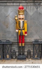 Large Nutcracker Soldier Statue In front of the gray wall