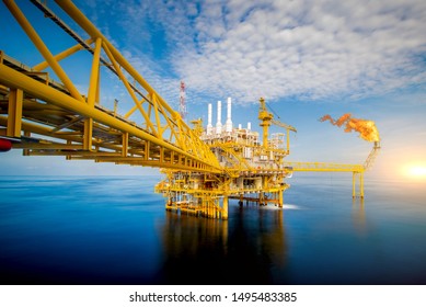 Large Offshore oil rig drilling platform at sunset and beautiful sky in the gulf of Thailand