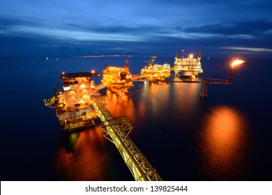 The  large offshore oil rig at night with twilight background