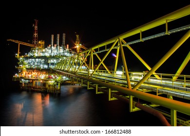 The Large Offshore Oil Rig At Night With Twilight Background