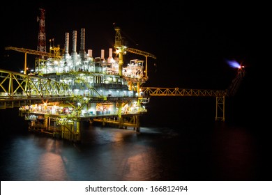 The Large Offshore Oil Rig At Night With Twilight Background