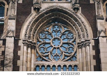 Large old openwork round window with stained glass on facade of the building. Baroque and Gothic architecture. Church of St. Olga and Elizabeth. Lviv, Ukraine. Stock photo © 
