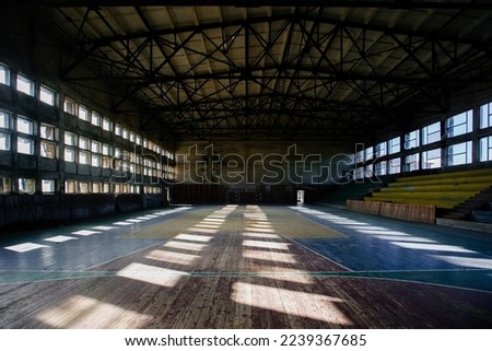Large old ruined gymnasium in abandoned school.