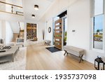 Large open concept great room with fireplace and wooden beams