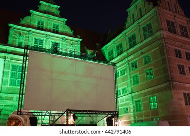 Large Outdoor Movie Projector Screen, Empty Display Ready For Projection At Night, Illuminated Green Gate, Old Town Of Gdansk, Poland