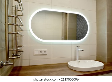 Large Oval Mirror And Overhead Washbasin In The Bathroom