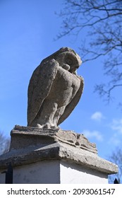 A Large Owl Figure On A Concrete Fence Post