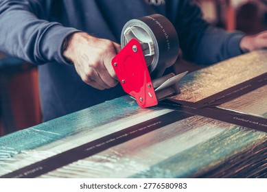 Large package carefully being wrapped