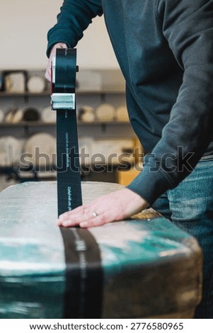 Large package carefully being wrapped