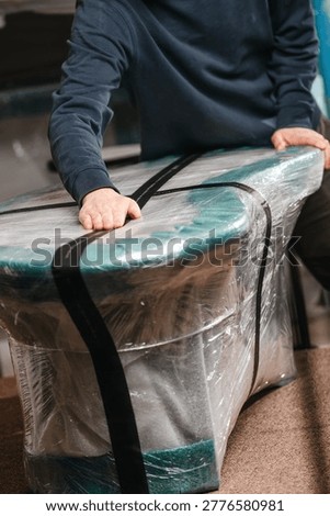 Large package carefully being wrapped