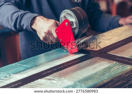Large package carefully being wrapped