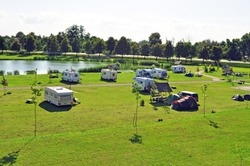 Large Parking Lot On A Green Meadow Near The Lake Shore For Mobile Homes, Campers, Trailers