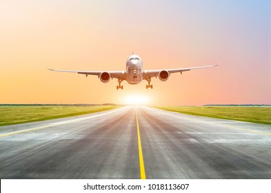 Large Passenger Plane Take Off From The Runway Before The Light From The Sunshine