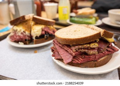 Large Pastrami Sandwiches, With The Reuben Filling At The Background.