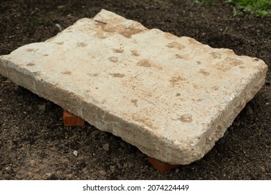 A Large Piece Of Concrete Lying On The Ground. Construction In Russia. Texture Of Stone, General Plan.