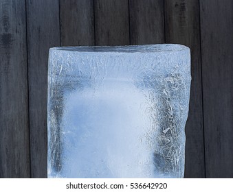 A Large Piece Of Ice On A Wooden Background