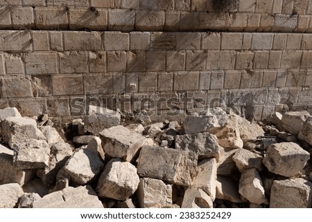 Large pieces of rock, believed to be ruins from the second Jewish Temple destroyed by the Romans in 70 AD, lie at the base of the Western Wall in Jerusalem. 