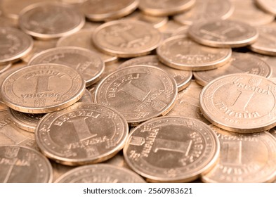 Large pile of big golden coins. Financial success money background for rich life concepts, banking and profit in Ukraine - Powered by Shutterstock