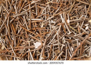 A large pile of old rusty nails and screws.