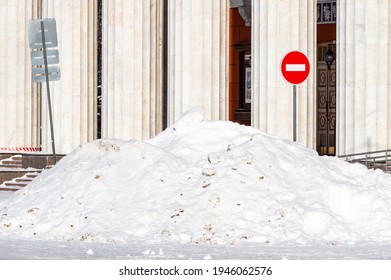 a large pile of snow in front of a building with columns. High quality photo - Shutterstock ID 1946062576