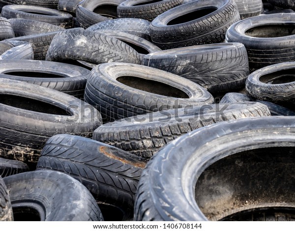 Large pile of tires dump. Illegal garbage\
dump. The concept of ecology\
pollution.
